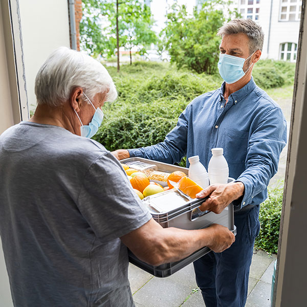 man delivery food to elder man